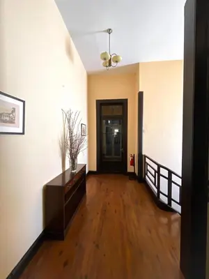 a living room with a wooden floor and a hallway at Casa da Avó Luísa in Funchal