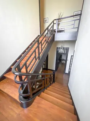 a staircase in a building with a metal railing at Casa da Avó Luísa in Funchal
