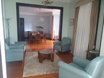 a living room with blue chairs and a table at Casa da Avó Luísa in Funchal