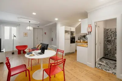 a kitchen and a living room with a table and chairs at Loft Arrifes by An Island Apart in Funchal