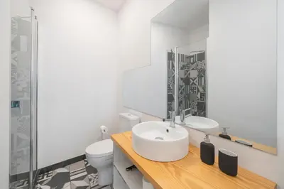 a white bathroom with a sink and a toilet at Loft Arrifes by An Island Apart in Funchal