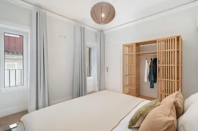 a white bedroom with a bed and a closet at Loft Arrifes by An Island Apart in Funchal