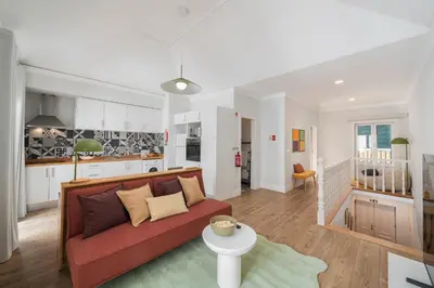 a living room with a red couch and a kitchen at Loft Arrifes by An Island Apart in Funchal