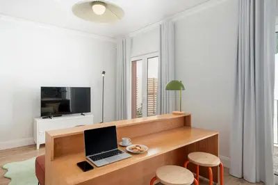 a living room with a desk with a laptop on it at Loft Arrifes by An Island Apart in Funchal