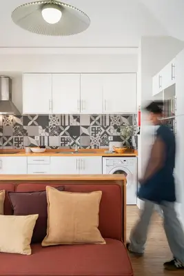 a man walking through a living room with a couch at Loft Arrifes by An Island Apart in Funchal