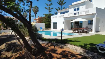 a villa with a swimming pool and a house at Dad's Villa in Lagos