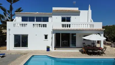 a villa with a swimming pool and a house at Dad's Villa in Lagos
