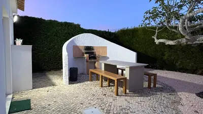 a kitchen with a table and a bench in a tunnel at Dad's Villa in Lagos