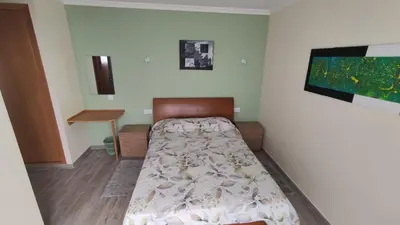 a bedroom with a bed and a tv on a wall at Villa do Italiane in Estreito da Calheta
