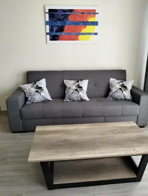 a living room with a couch with a coffee table at Villa do Italiane in Estreito da Calheta