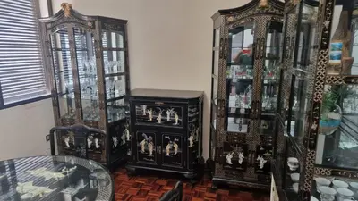 a room with two china cabinets and a glass table at Vila Boa Nova Funchal in Funchal