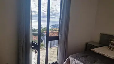 a bedroom with a window with a view of a balcony at Vila Boa Nova Funchal in Funchal