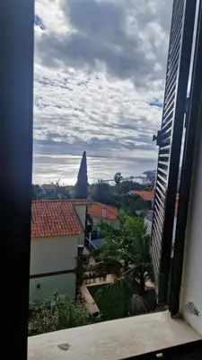 a view from a window of a city with a rock at Vila Boa Nova Funchal in Funchal