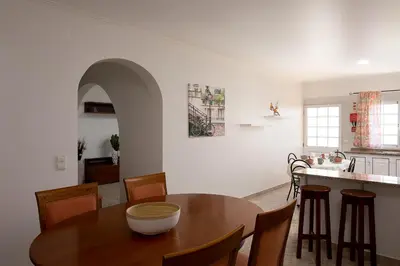 a kitchen and dining room with a table and chairs at Franco's House, mar e serra in Estreito da Calheta
