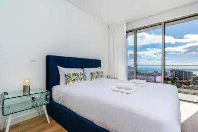 a bedroom with a large bed and a large window at Eden Loft by Madeira Dream Stays in Funchal