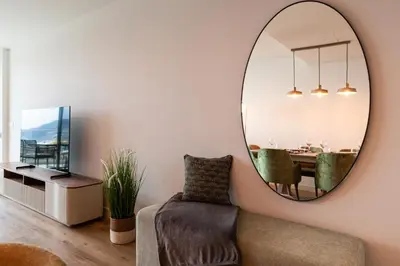 a living room with a mirror and a table at Eden Loft by Madeira Dream Stays in Funchal