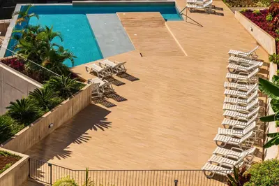 a swimming pool with lounge chairs and a swimming pool at Eden Loft by Madeira Dream Stays in Funchal