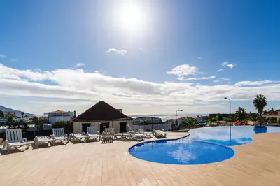 a large swimming pool with chairs at Eden Loft by Madeira Dream Stays in Funchal
