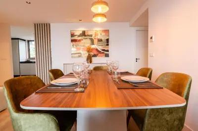 a dining room with a wooden table and chairs at Eden Loft by Madeira Dream Stays in Funchal