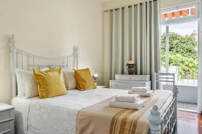 a bedroom with a large bed with towels on it at Cantinho dos Ilhéus in Funchal
