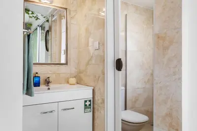 a bathroom with a toilet and a sink and a shower at Cantinho dos Ilhéus in Funchal