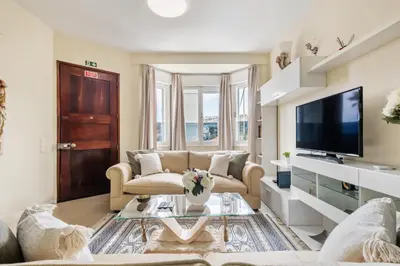 a living room with a couch and a tv at Cantinho dos Ilhéus in Funchal