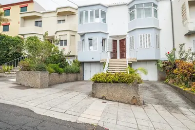 a white house with a staircase in front of it at Cantinho dos Ilhéus in Funchal