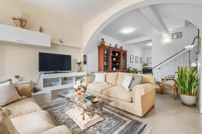 a living room with two couches and a tv at Cantinho dos Ilhéus in Funchal