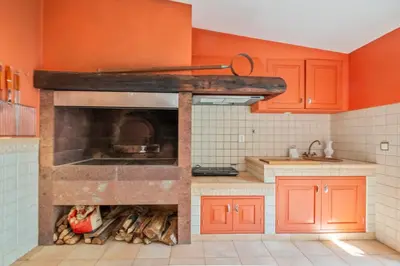 a kitchen with an oven with orange walls at Villa Diniz by Madeira Dream Stays in Funchal
