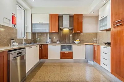 a kitchen with wooden cabinets and white appliances at Villa Diniz by Madeira Dream Stays in Funchal