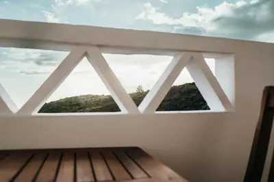 a living room with a chair and a table at Cristo Rei Ocean View in Caniço