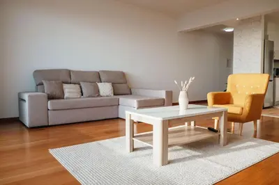 a window in a white room with a wooden deck at Cristo Rei Ocean View in Caniço