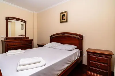 a bedroom with a bed with a dresser and a mirror at Vila do Conde Nº3 in Ribeira Brava