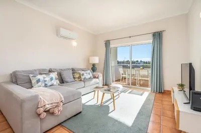 a living room with a couch and a television at Host Wise - Bright & Stylish Lagos Flat with Pool in Lagos
