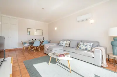 a living room with a couch and a table at Host Wise - Bright & Stylish Lagos Flat with Pool in Lagos