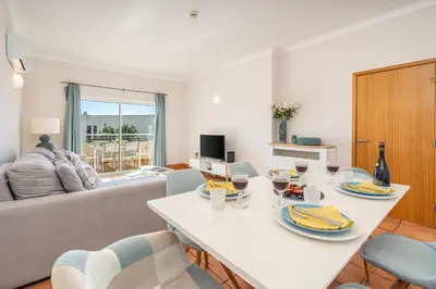 a living room with a white table and chairs at Host Wise - Bright & Stylish Lagos Flat with Pool in Lagos