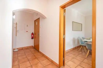 a hallway with a door leading to a dining room at Host Wise - Bright & Stylish Lagos Flat with Pool in Lagos
