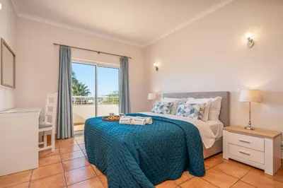 a bedroom with a bed and a large window at Host Wise - Bright & Stylish Lagos Flat with Pool in Lagos