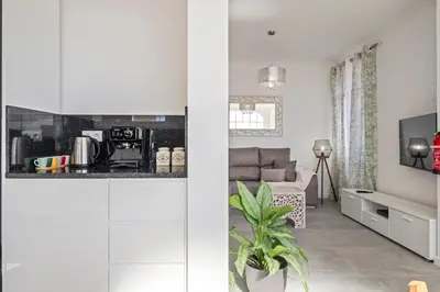 a kitchen and living room with white walls at Betty's Villa by ALMA Holiday Rentals in Funchal