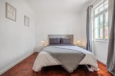a white bedroom with a bed and two lamps at Betty's Villa by ALMA Holiday Rentals in Funchal
