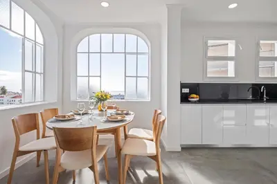 a kitchen and dining room with a table and chairs at Betty's Villa by ALMA Holiday Rentals in Funchal