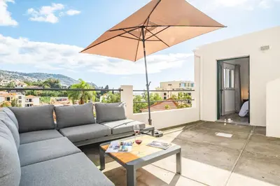 a living room with a couch and an umbrella at Betty's Villa by ALMA Holiday Rentals in Funchal