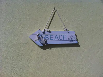 a balcony with a table and a view of the ocean at House on the Beach in Machico