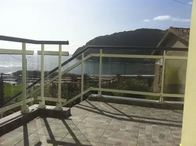 a window with a view of the ocean at House on the Beach in Machico