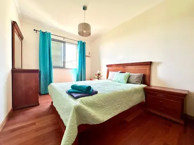 a bed with two towels sitting on top of it at Rooms for Rent Residence Funchal in Funchal