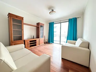 a kitchen with wooden cabinets and a microwave at Rooms for Rent Residence Funchal in Funchal