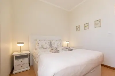 a white bedroom with a white bed and two lamps at Casa da Jackie by Rent-a-key in Funchal