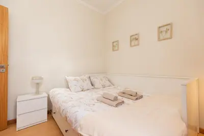 a white bedroom with a bed with two pillows on it at Casa da Jackie by Rent-a-key in Funchal