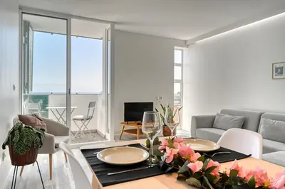 a living room with a table and a couch at Maranta House, a Home in Madeira in Funchal