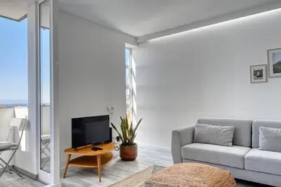a living room with a couch and a tv at Maranta House, a Home in Madeira in Funchal
